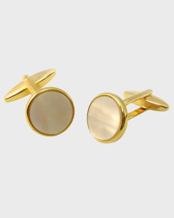 Gilt and white cufflinks on a light gray background