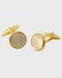 Gilt and white cufflinks on a light gray background