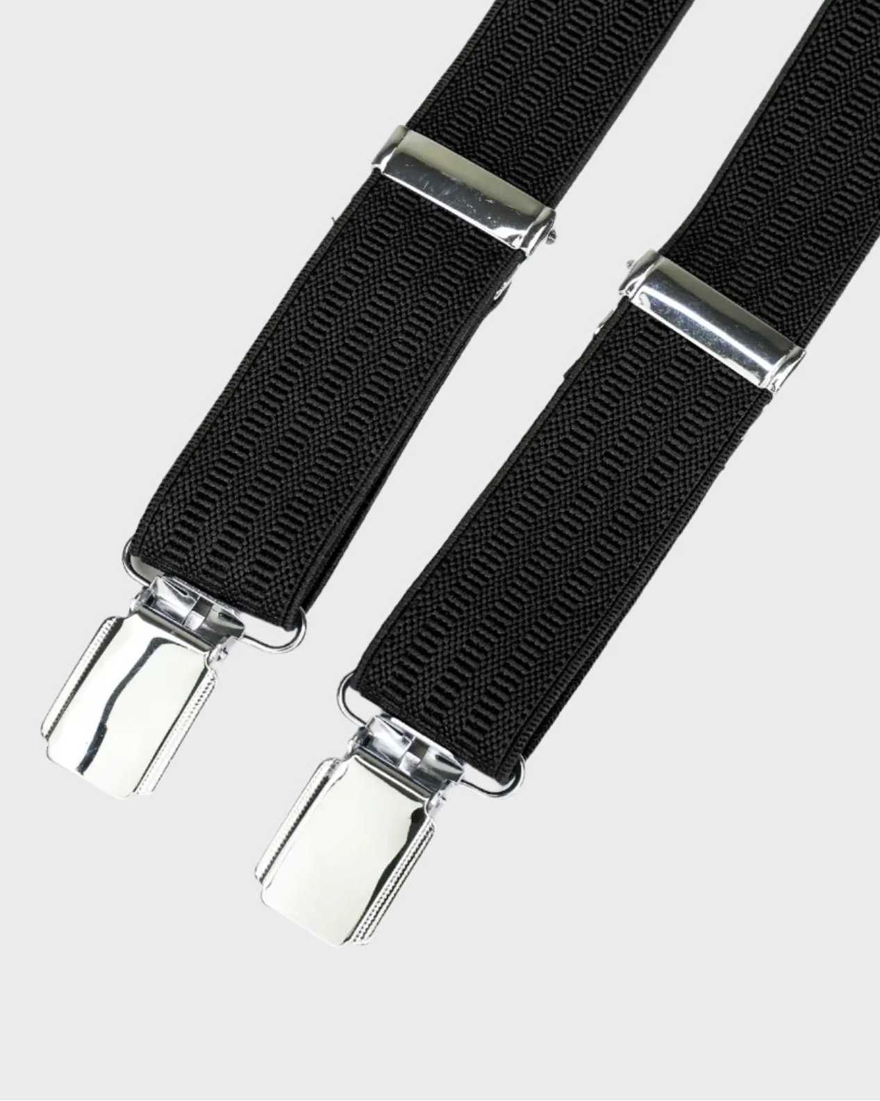 Black braces with silver clips on a light gray background