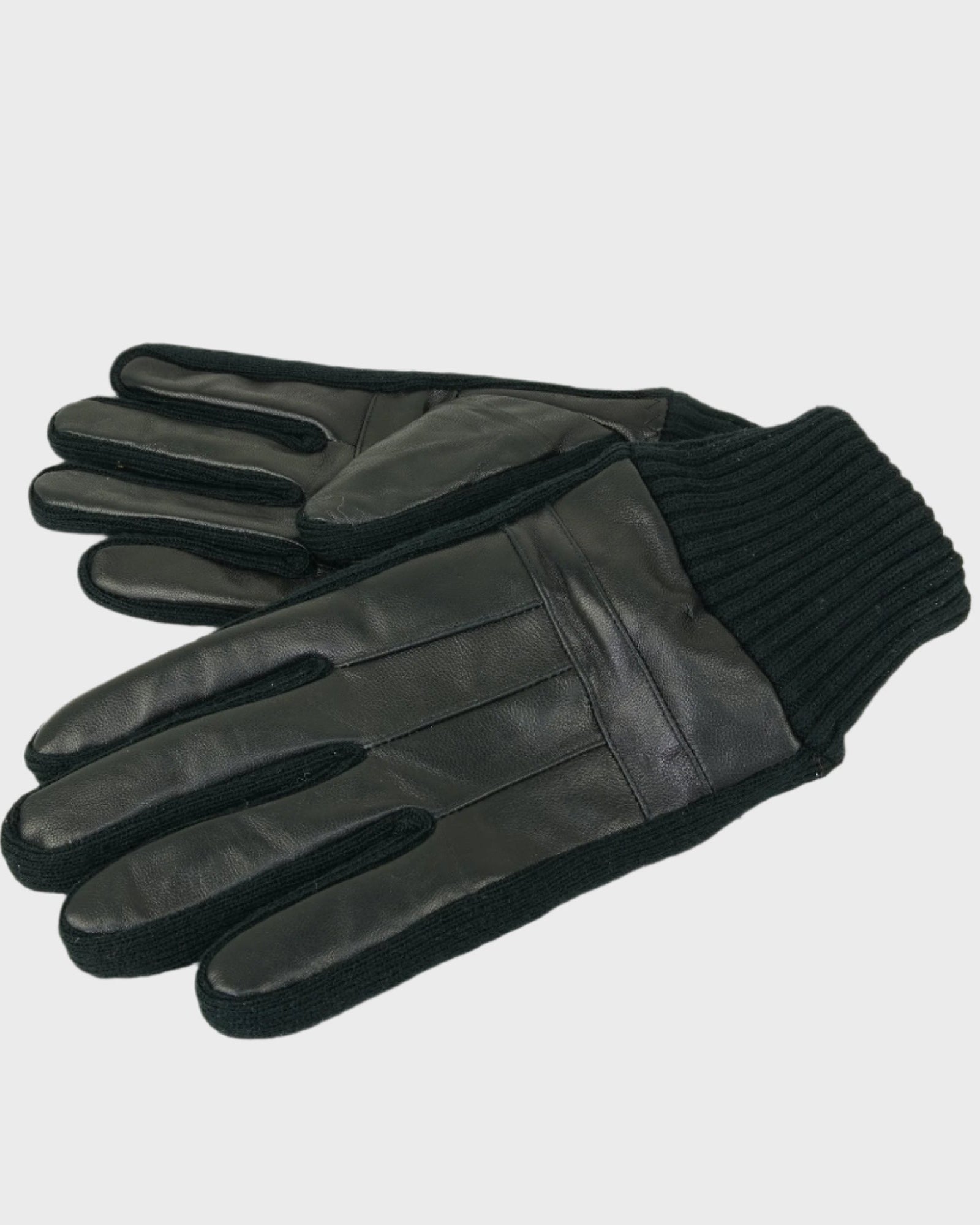Pair of black leather gloves with ribbed cuffs on a light gray background