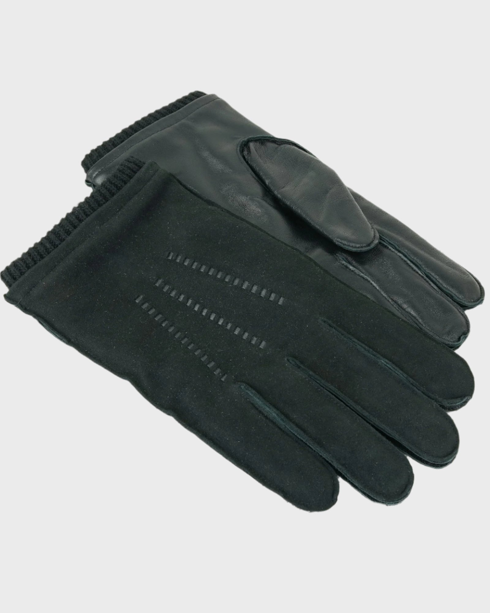 Pair of black gloves on a light gray background