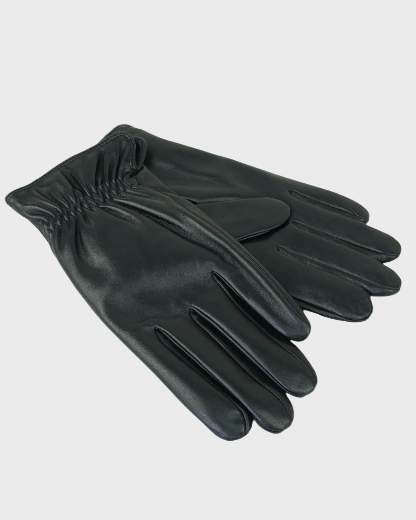 Pair of black leather gloves on a light gray background