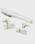 Silver cufflinks and tie clip set with gold accents on a white background