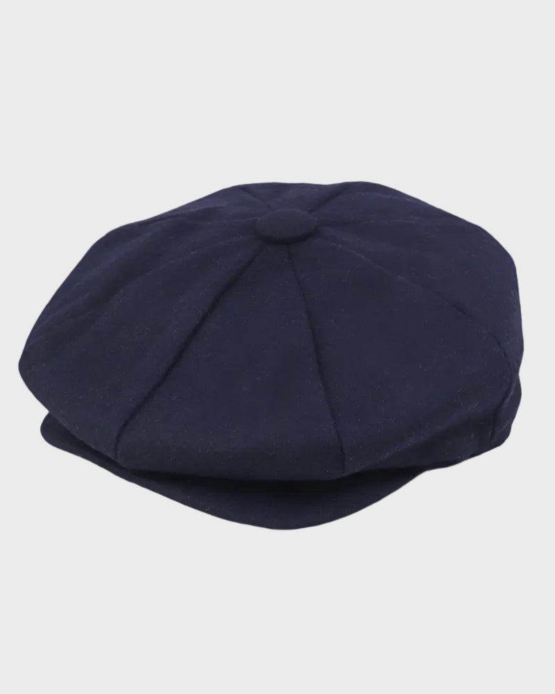 Navy blue flat cap on a light gray background
