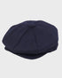 Navy blue flat cap on a light gray background