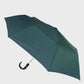 Green umbrella on a light gray background