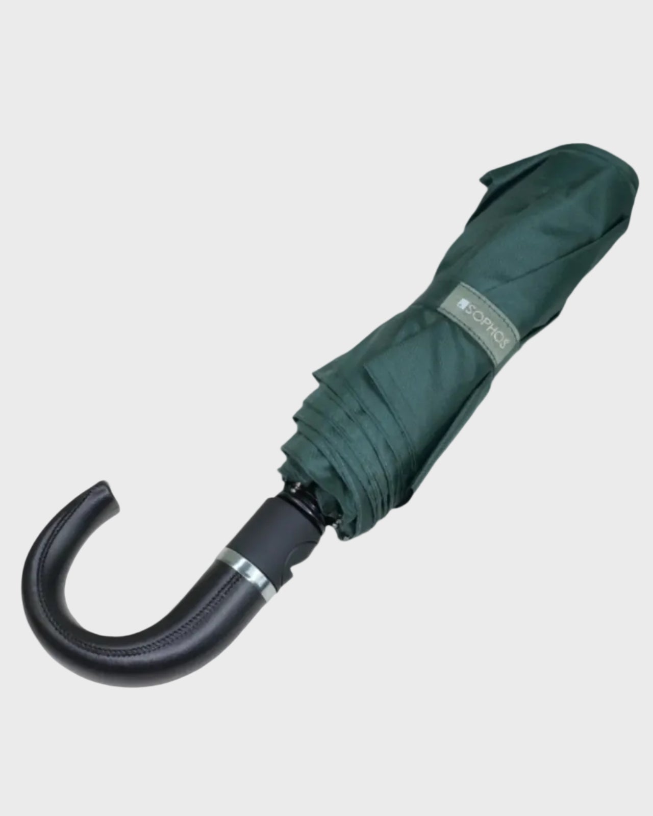 Green umbrella with black handle on a light gray background