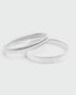 Silver armbands on a light gray background