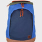 A blue and navy backpack with orange drawstring cords, a brown base trim, and an olive green top flap, shown against a light gray background.