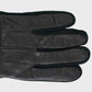 Black leather glove on a light gray background
