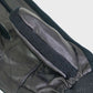 Close-up of black leather gloves with knitted cuffs on a light gray background