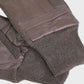 Brown leather gloves with knitted cuffs on a light gray background