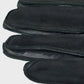 Black leather gloves on a light gray background