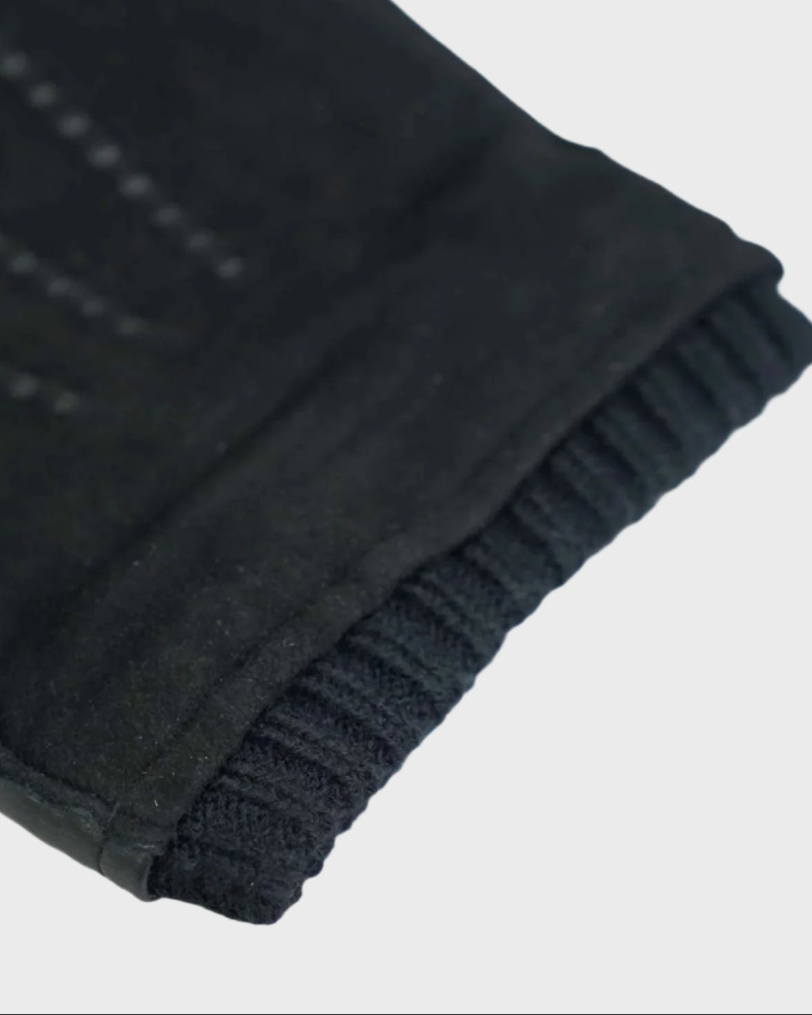 Black gloves on a light gray background