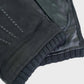 Close-up of a black leather gloves on a light gray background