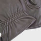 close up of leather gloves on a light gray background