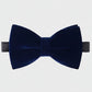 Navy blue velvet bow tie on a light gray background