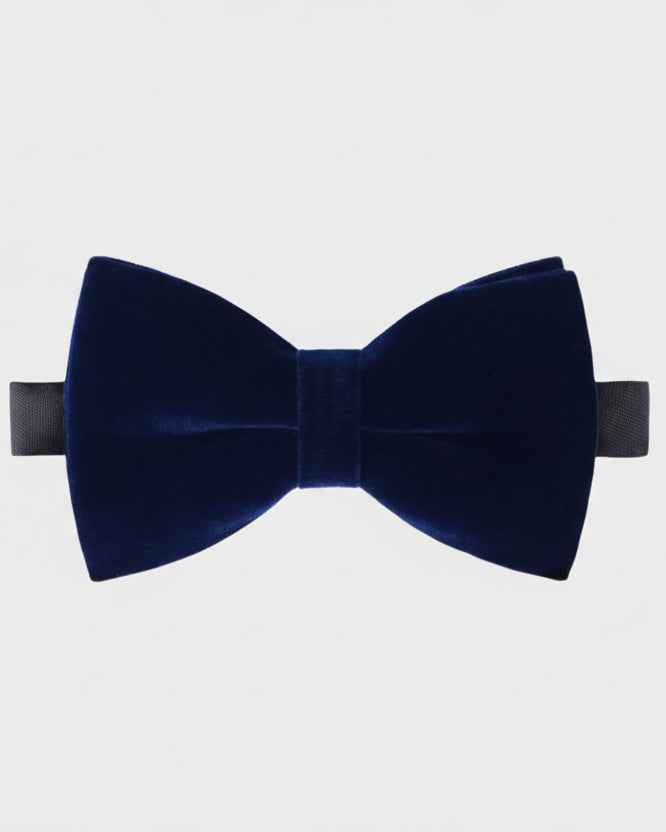 Navy blue velvet bow tie on a light gray background