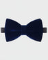 Navy blue velvet bow tie on a light gray background