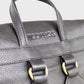 Close-up of a black leather backpack with visible brand name on a light gray background