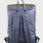 Navy backpack with green accents on a light gray background