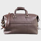 Brown leather holdall with shoulder strap on a light gray background