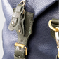 Close-up of a leather holdall on a light gray background