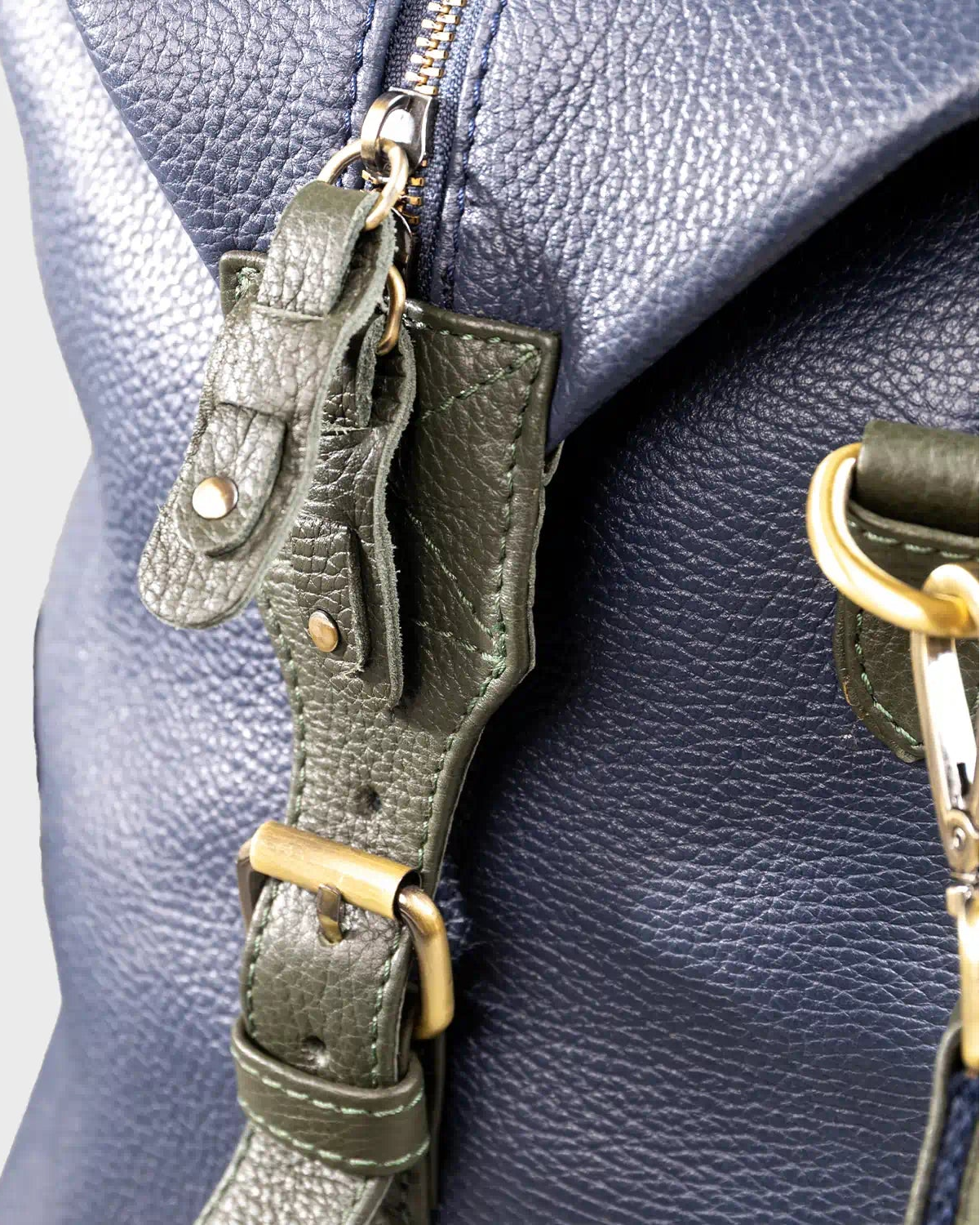 Close-up of a leather holdall on a light gray background