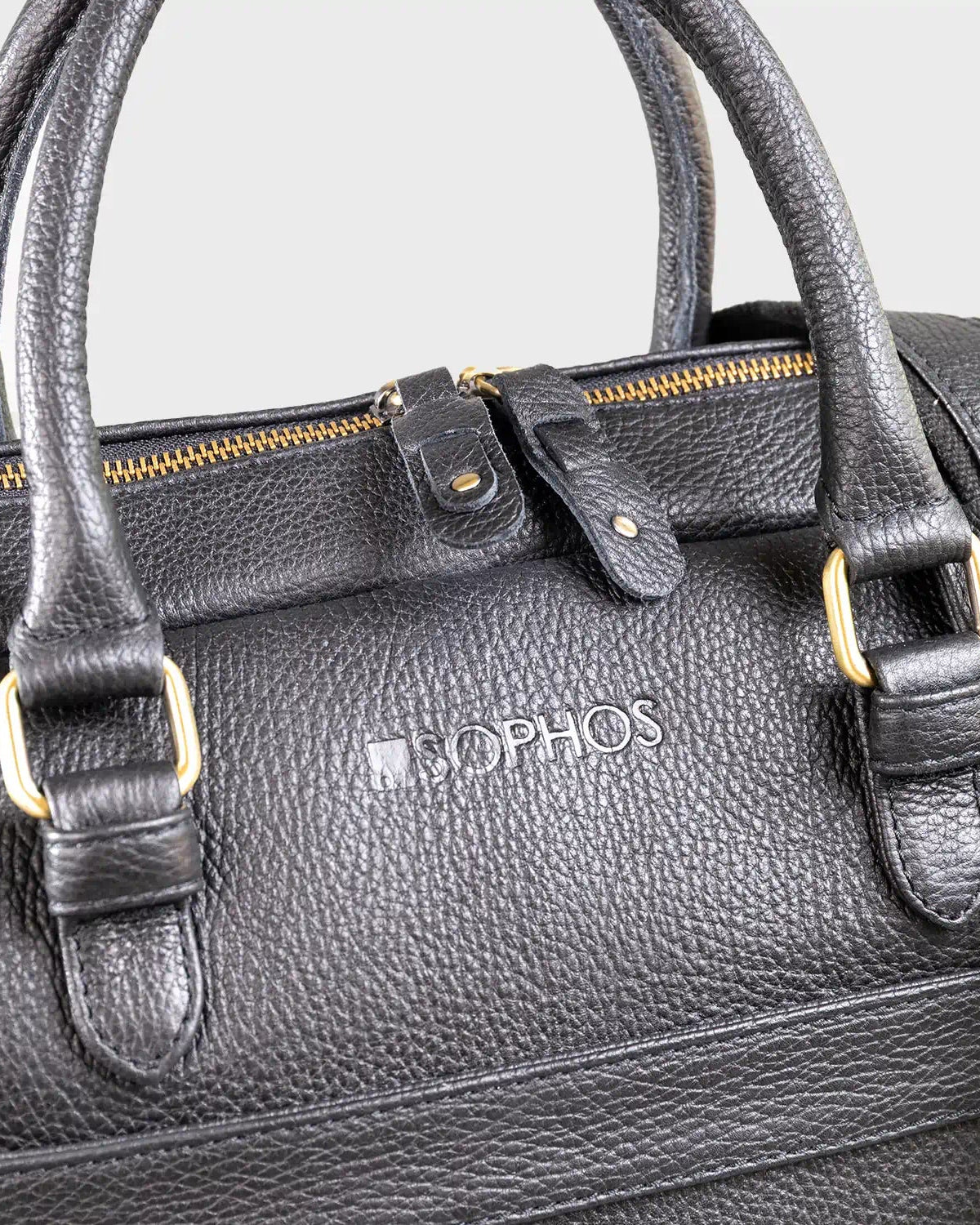 Black leather bag with gold accents and 'SOPHOS' branding on a light gray background