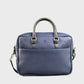 Blue leather bag with a strap on a grey background