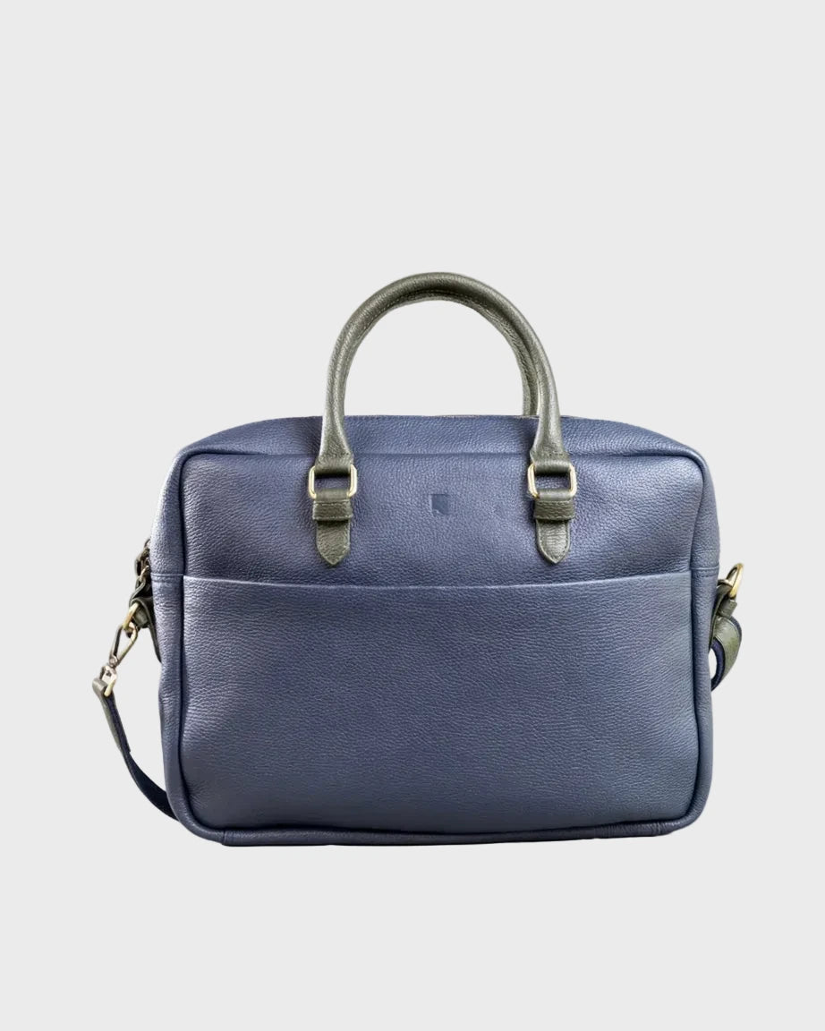 Blue leather bag with a strap on a grey background