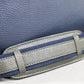 Gray and blue belt strap on a textured blue background