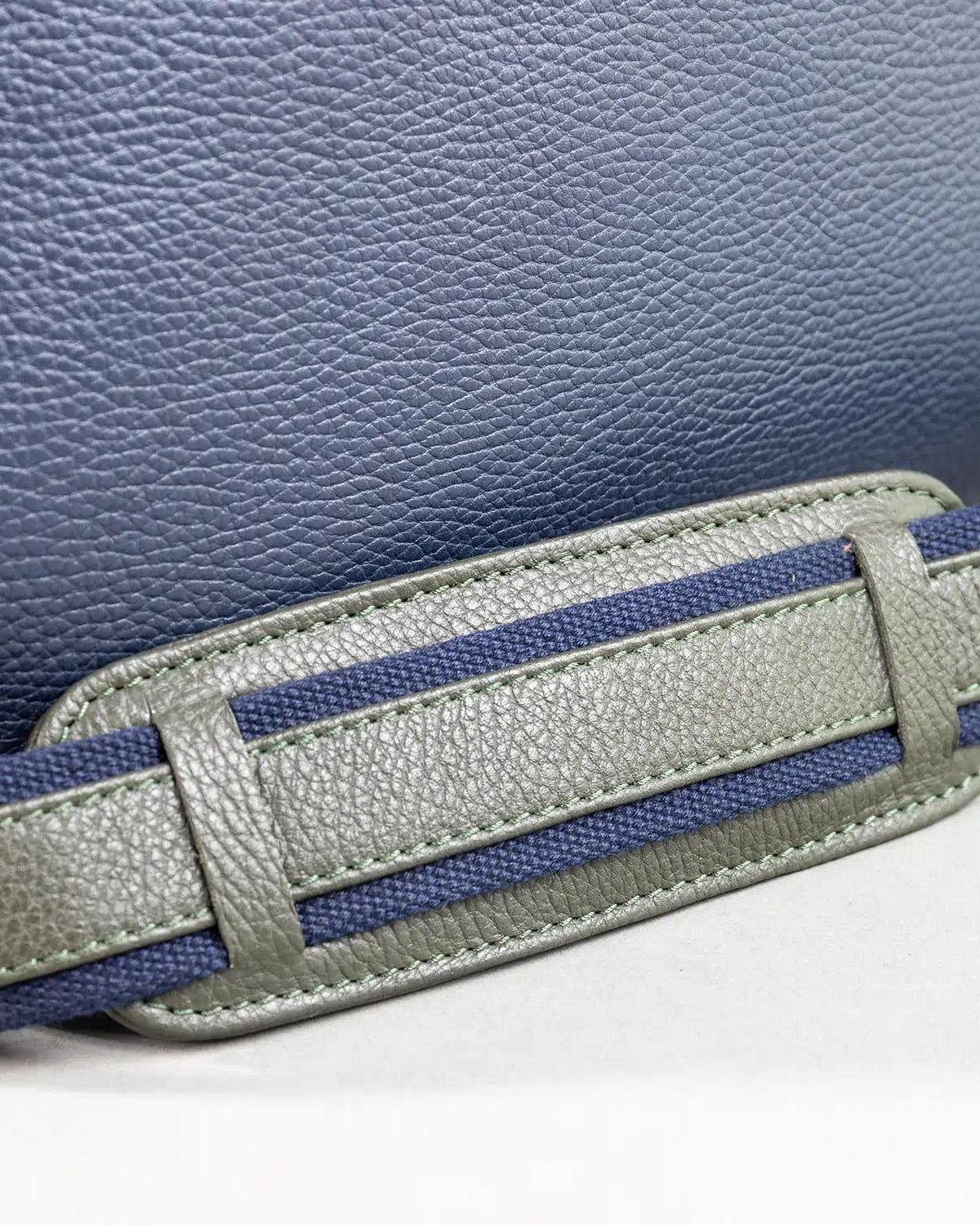 Gray and blue belt strap on a textured blue background