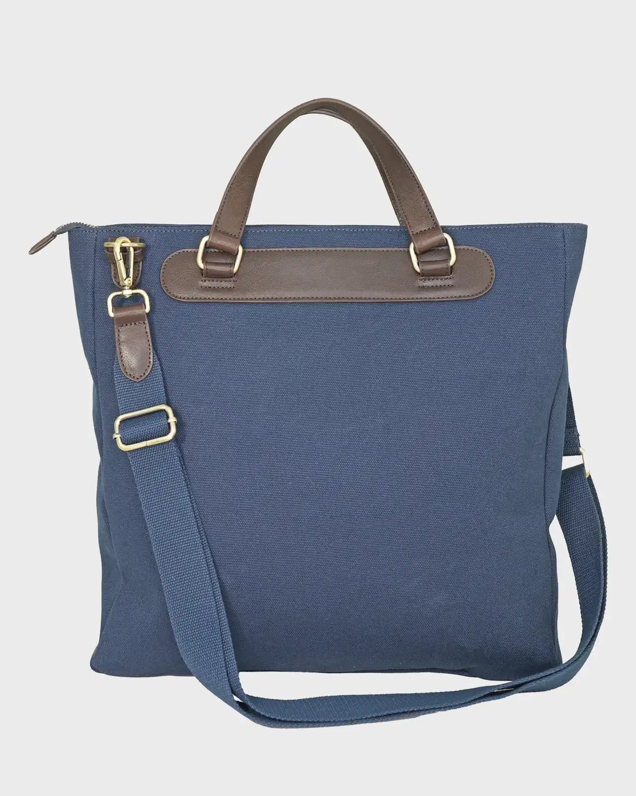 Navy bag with brown leather straps on a light gray background