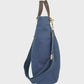 Navy bag with brown leather straps on a light gray background