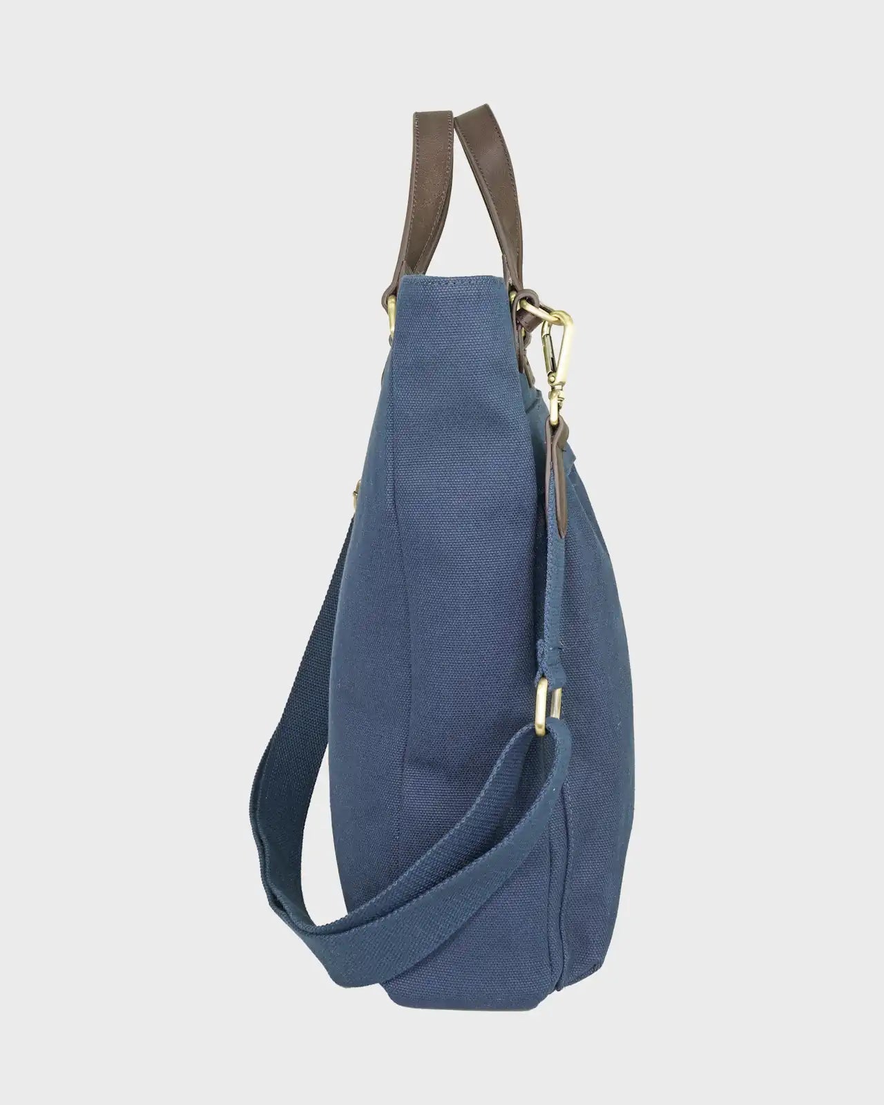 Navy bag with brown leather straps on a light gray background