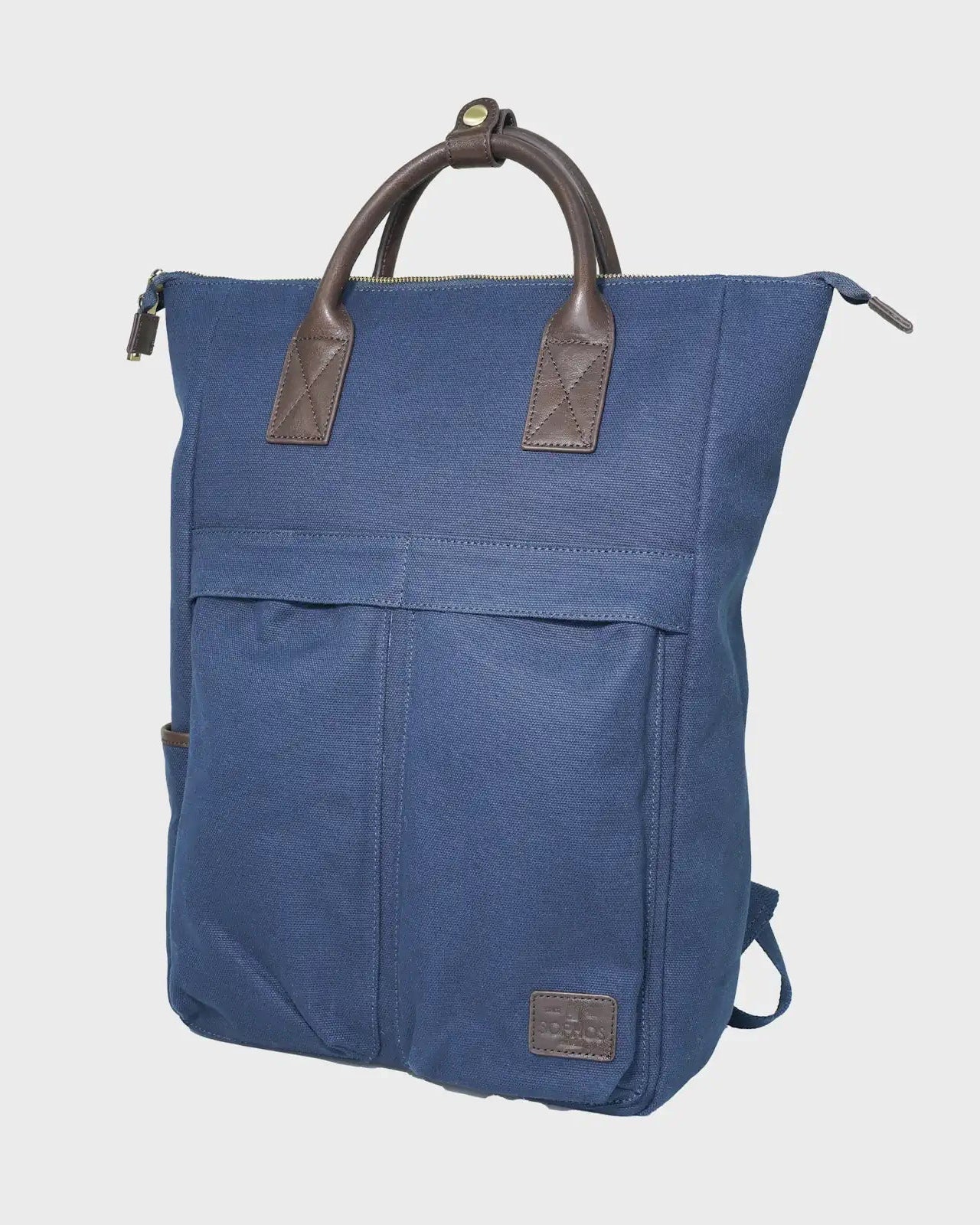 Navy backpack with brown handles on a light gray background