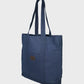 Navy tote bag with a brown patch on a light gray background
