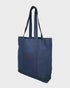 Navy tote bag with a brown patch on a light gray background
