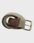 woven belt with a brass buckle on a light gray background