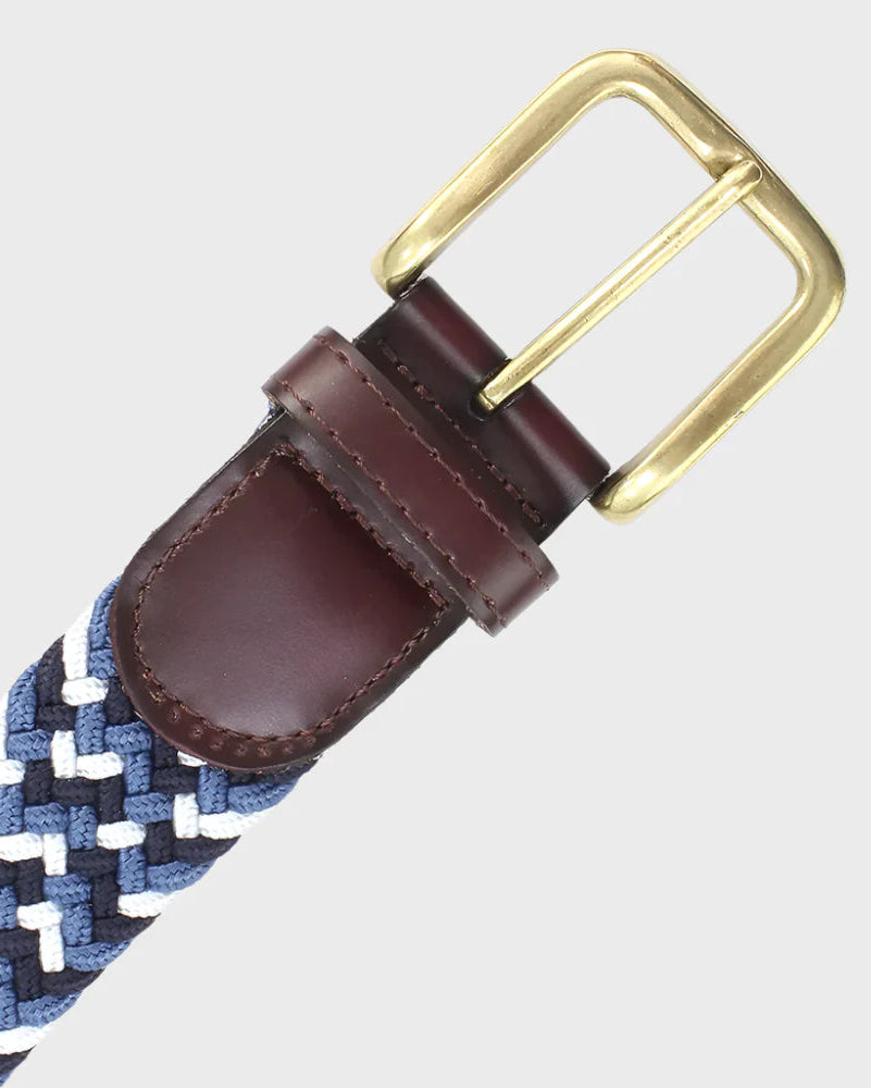 Braided belt with brown leather strap and brass buckle on a light gray background