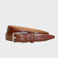 Tan leather belt with a silver buckle on a light gray background