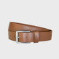 Tan leather belt with a silver buckle on a light gray background