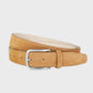 Tan belt with a silver buckle on a light gray background