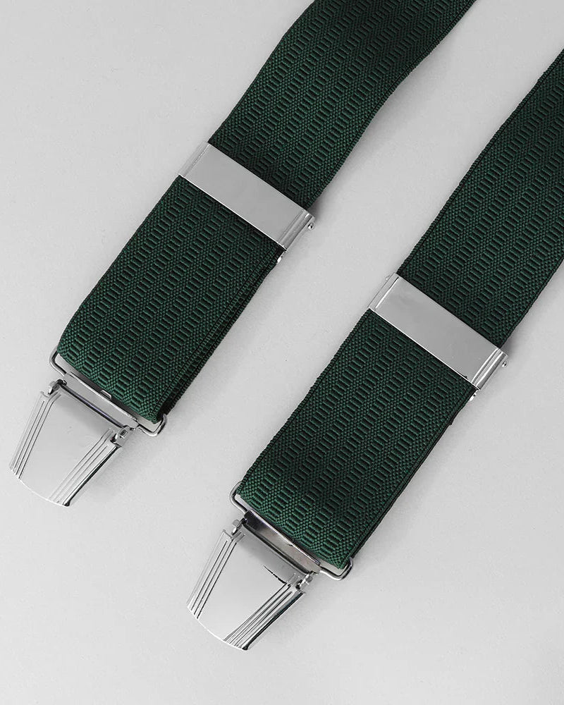 Green braces with silver clips on a light gray background