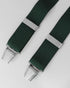 Green braces with silver clips on a light gray background