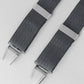 Grey braces with silver clips on a light gray background