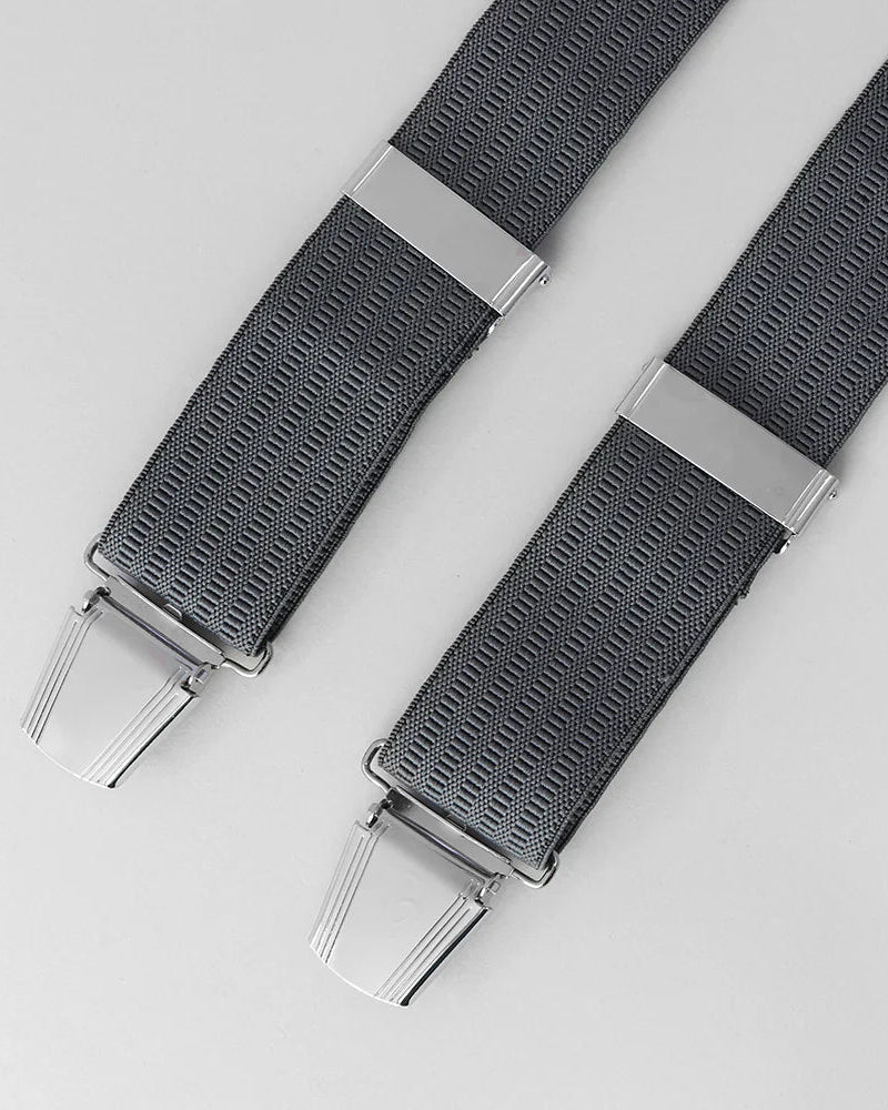 Grey braces with silver clips on a light gray background