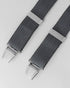 Grey braces with silver clips on a light gray background