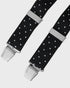 Black polka dot braces with silver clasp on a light gray background